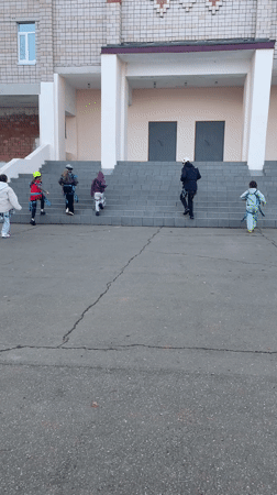 Group climbs building stairs in Sarapul, Russia early morning
