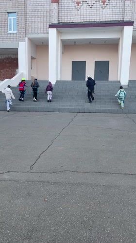 Group climbs building stairs in Sarapul, Russia early morning