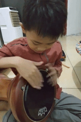 Traditional hand drumming session on a wooden floor in Palembang