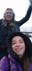 Women film selfies, group shares outdoor meal during dusk