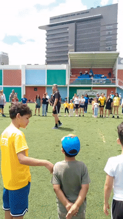 Kids' community event on a Caracas turf field with clowns and coaching