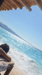 Relaxing on a wooden deck above turquoise coastal waters