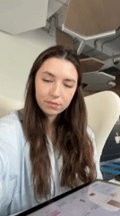 Woman with tablet observed in white chair in Moscow