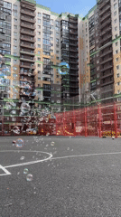 Family creates soap bubble play session at Khimki sports courts