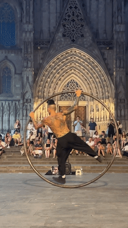Metal hoop acrobatics in a Barcelona Gothic Quarter plaza