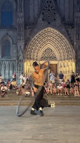 Metal hoop acrobatics in a Barcelona Gothic Quarter plaza