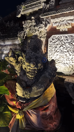 Ubud scenes: decorated temple statue and nighttime motorcycle ride