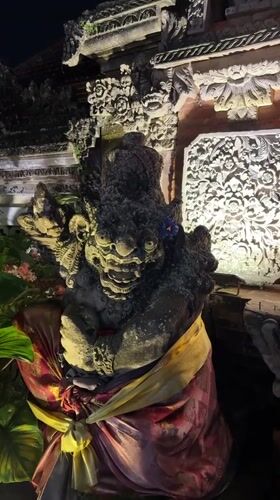 Ubud scenes: decorated temple statue and nighttime motorcycle ride