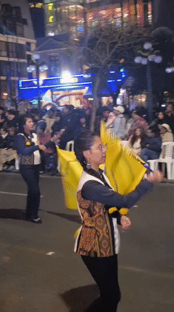 Night parade with yellow flags lights up La Paz streets
