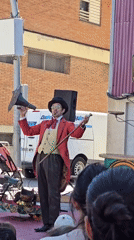 Vintage-styled performer with gramophone horn entertains crowd in Cornellà