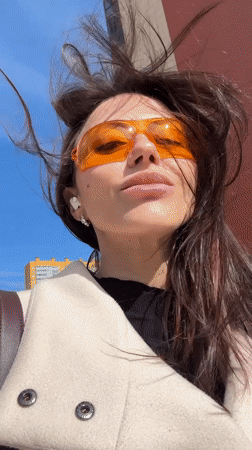 Woman in orange glasses documented around Murino, Russia apartment complex