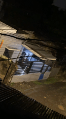 Person walks with umbrella through rainy Davao City evening