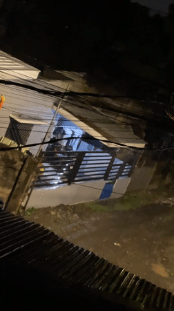 Person walks with umbrella through rainy Davao City evening