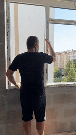 Window installation and rooftop work at a Burgas building site