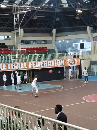 Young women hold basketball practice in Nairobi gymnasium