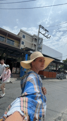 Woman takes selfie in patterned room in Patong