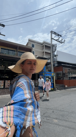 Woman takes selfie in patterned room in Patong