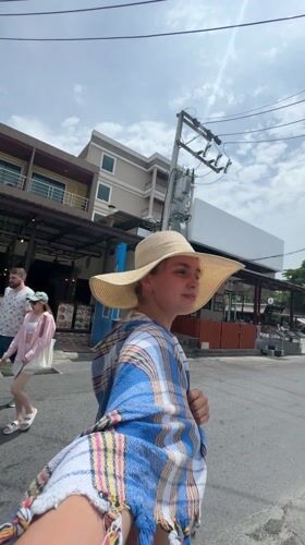 Woman takes selfie in patterned room in Patong