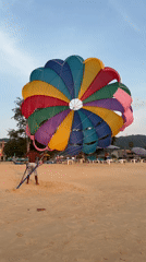 Tourists photograph sunset at Karon Beach, Thailand