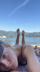 Women enjoy beach day with cat in Budva Montenegro