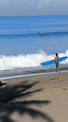 Surfers gather at Dalung beach on sunny evening
