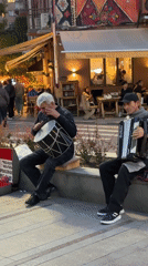 Street musicians perform drum and accordion in Yerevan