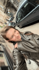 Woman takes selfies in brown leather jacket, Belgrade
