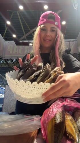 Odesa market vendor shows off fish and dried goods