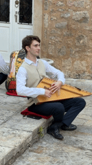 Zither played on stone steps in Budva, Montenegro