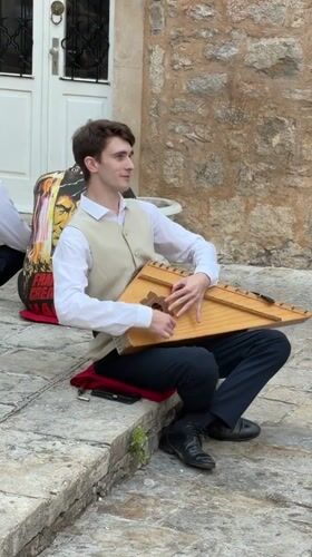 Zither played on stone steps in Budva, Montenegro