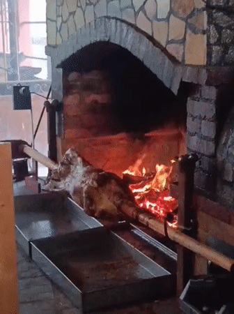 Whole pig on a spit over open fire in Konush, Bulgaria