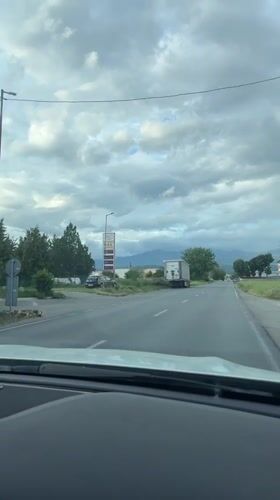 Mercedes drives past trucks and gas station in Blagoevgrad