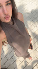 Woman films selfies near bronze statue in Aventura public space