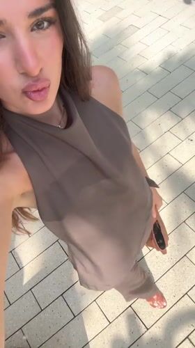 Woman films selfies near bronze statue in Aventura public space