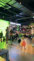 Live band rocks a small indoor venue under green stage lights