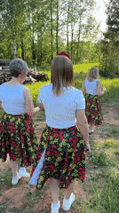 Women in matching floral outfits gather for celebration in Markovo