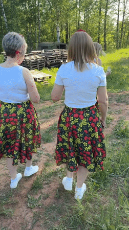 Women in matching floral outfits gather for celebration in Markovo