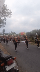 Civic parade with marching bands and vintage jeeps in Sumbersekar