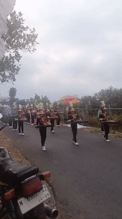 Civic parade with marching bands and vintage jeeps in Sumbersekar