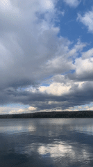 Woman documents lakeside afternoon in Chaikovsky, Russia