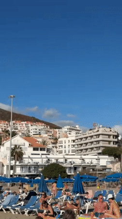 Beachgoers enjoy sunny afternoon at Los Cristianos resort