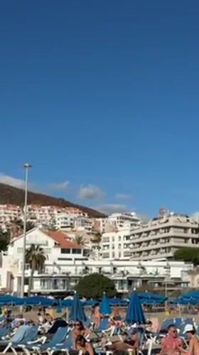 Beachgoers enjoy sunny afternoon at Los Cristianos resort