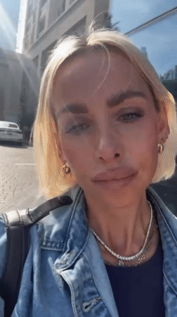 Woman puts on sunglasses on Dubai street