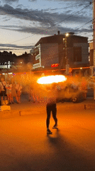 Fire performance draws a street crowd in Vityazevo at dusk