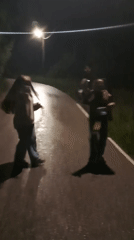 Two people dance on wet street in Gabrovo
