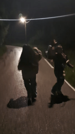 Two people dance on wet street in Gabrovo