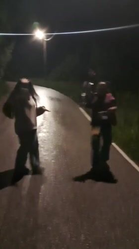 Two people dance on wet street in Gabrovo