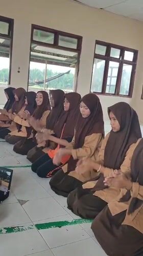 Students perform synchronized dance routine in Indonesian classroom