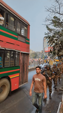 Morning street life documented across Dhaka neighborhoods includes military patrol
