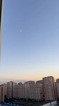 Krasnodar skyline at sunset with a crescent moon rising